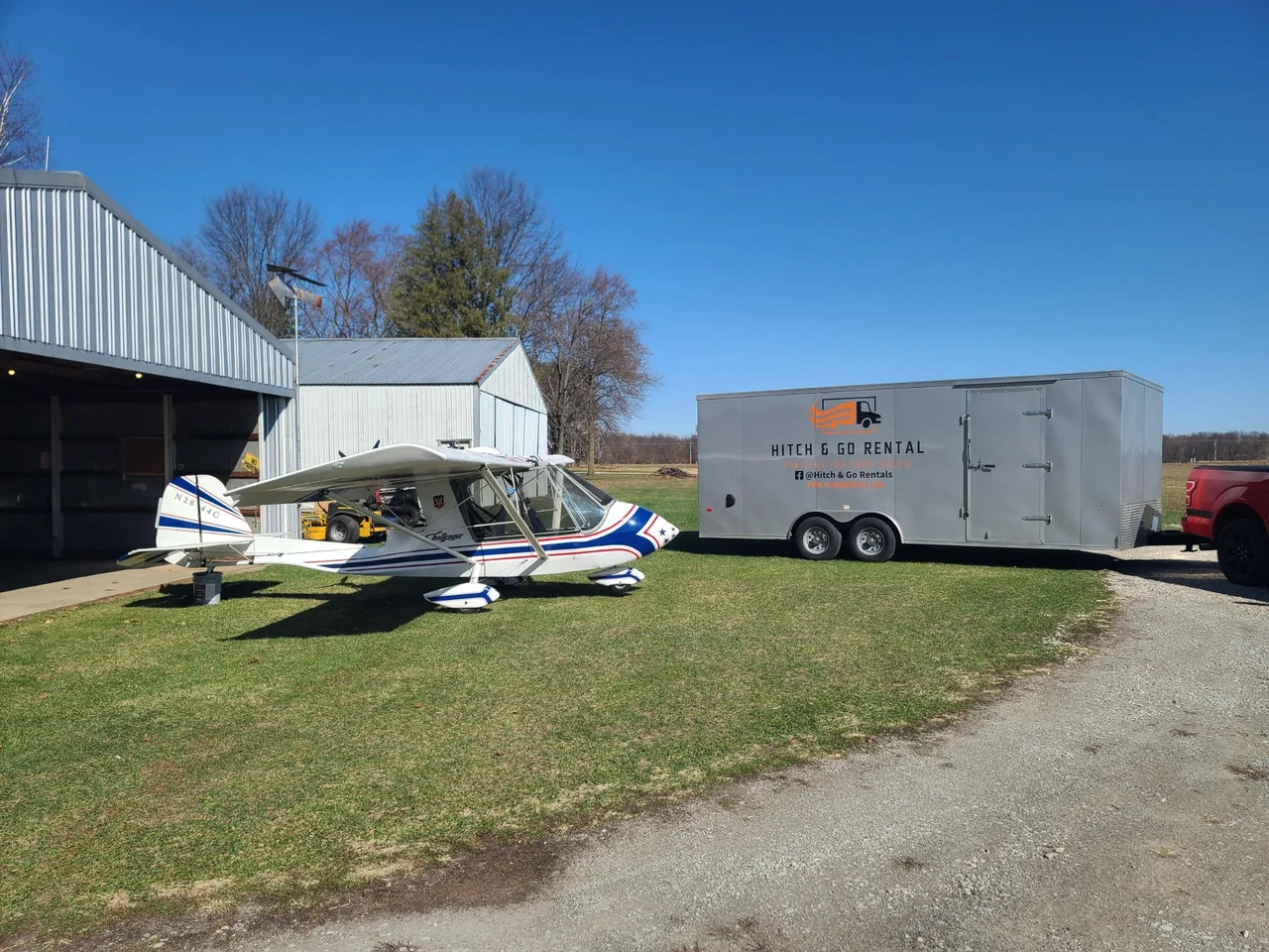 Hitch & Go enclosed trailer parked outdoors beside a boat