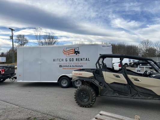 Hitch & Go enclosed trailer parked beside a side-by-side